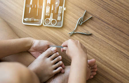 Woman cutting nails,with blur tools of a manicure set,closeupの写真素材
