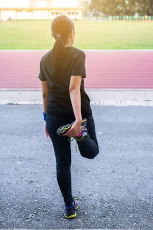 Athletic woman warming up before workout,Runner training outdoors,healthy lifestyle conceptの写真素材