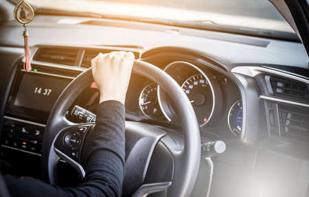 Woman driver hands holding steering wheel,Selective focus
