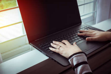 Close up hands woman working using laptop and connecting wifi,Toned image