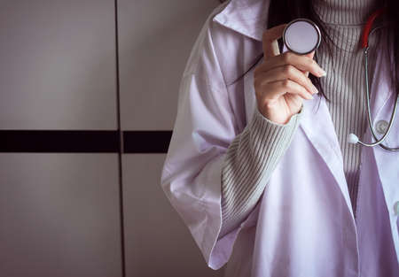 Medical stethoscope in hand,Doctor holding examination device for pulse,Healthcare and medical conceptの写真素材