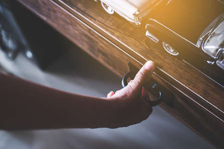 Hand open drawer box of wooden table,Vintage tonedの写真素材