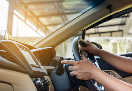 Hand driver using turn signal control light in carの写真素材