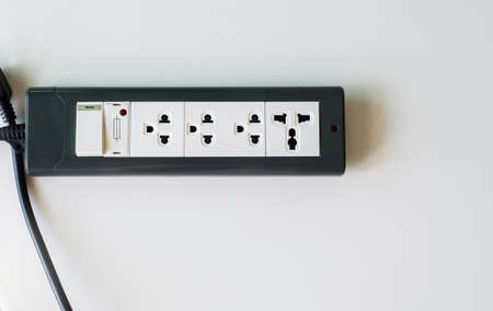 Hand with electric plug or puts plugs in the socket の写真素材