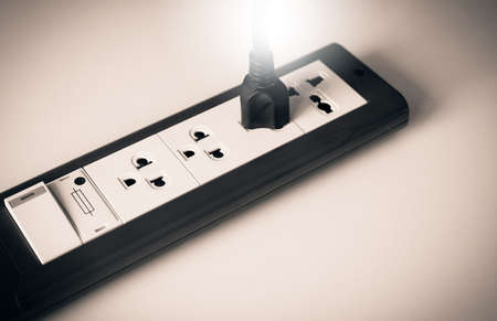 Hand with electric plug or puts plugs in the socket の写真素材