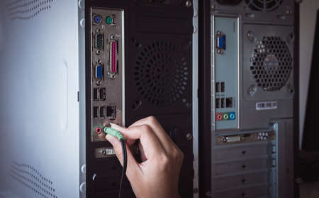 Hand with tech cable or audio plug computerの写真素材