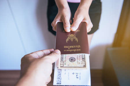 Passport with fight ticket on hand ,Traveler showing to staffの写真素材