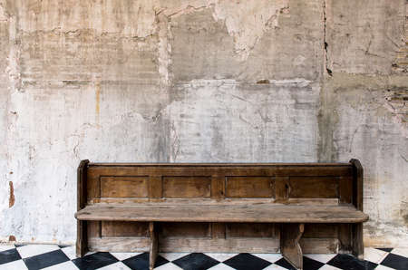 Old wooden seat with cement wall,Concrete wall texture grunge backgroundの写真素材