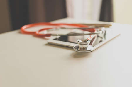 Stethoscope red on table,Healthcare and medical concept,Selective focus