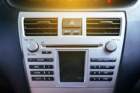 Car radio and air system,Button on dashboard in car panel dirtyの写真素材