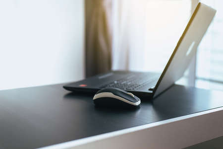Close up of laptop computer and mouse on desk,Selective focusの写真素材