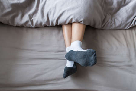 Close up of foot with socks,Feet on the bedの写真素材