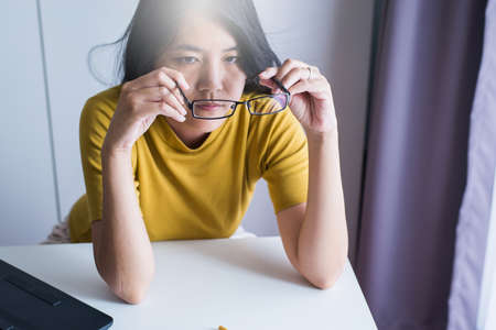Hand woman cleaning her glasses with cloth,Clean lenses of eyeglassesの写真素材