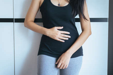 Woman having painful stomachache,Female suffering from abdominal painの写真素材