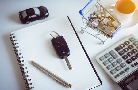 Saving money for cars with coins on mini shopping trolley cart,Car finance and loan conceptの写真素材