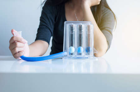 Asian female patients using incentivespirometer or three balls for stimulate lung following surgeryの写真素材