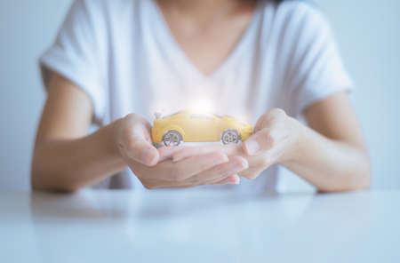 Car model toy on hand,Business and finance conceptの写真素材