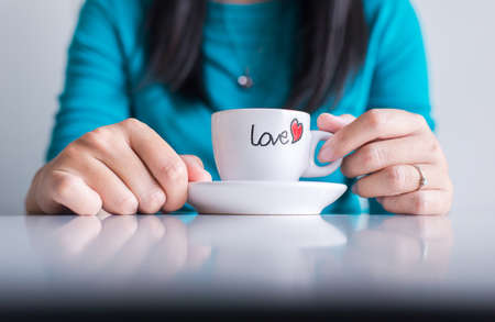 Woman hand with a cup of coffee,close upの写真素材