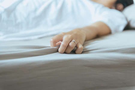Hand woman sign orgasm,Hand female pulling  bedsheet,Concept of sexual relations,Selective focus