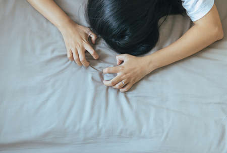Hand woman sign orgasm,Hand female pulling gray bedsheet,Concept of sexual relationsの写真素材