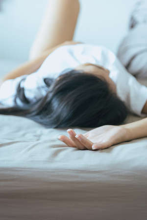Hand woman sign orgasm,Hand female on bed,Concept of sexual relations,Selective focusの写真素材