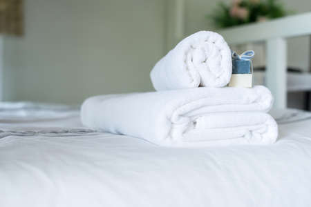 White towel on bed,Stack of plush hotel towelsの写真素材