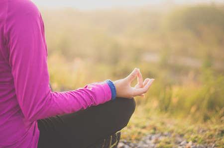 Woman sitting on road practicing doing yoga exercise and workout,Healthy and  lifestyle conceptの写真素材