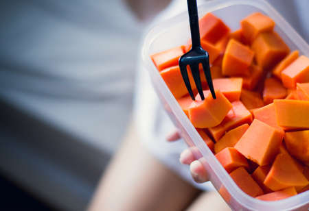 Woman eating fresh fruits papaya slices,Concept healthy food 
