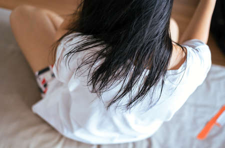 Young asian woman drying  hair with towel,Female drying her long hair with comb