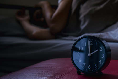 Insomnia in asian women on her bedroom,Female lying  suffering from headacheの写真素材