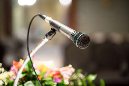 Old microphone on blurred in seminar room or conference hall backgroundの写真素材