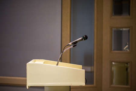 Microphone on blurred in seminar room or conference hall backgroundの写真素材