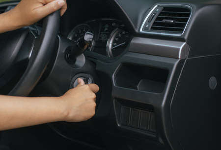 Hand woman driver holding car keys and start the engine with modern car