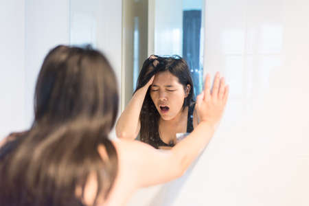Pregnant female nausea into basin at lavatory,Woman with morning sickness at front of mirror