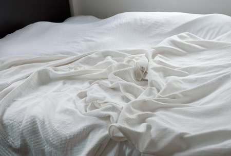 Wrinkles on bed sheet after waking up in the morningの写真素材