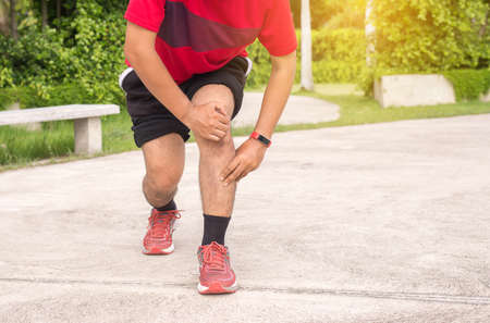 Man suffering from pain in leg injury after sport exercise running jogging and workout outdoor