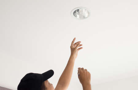 Hands mechanic changing with new LED lamp light bulb,Power saving concept