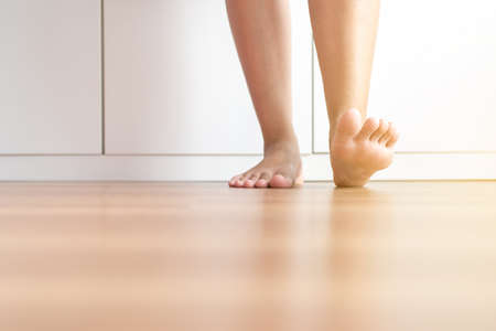 Barefoot asian woman clean and solf skin on the wooden floorの写真素材