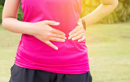 Woman suffering have stomach pain,Female runner side cramps while sport exercise running