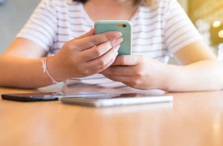 Hands woman using mobile phone,social media,relaxed girl checking cell phone at coffee...