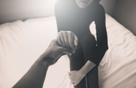 Man giving hand to depressed woman,Such as making a fresh start, and loving yourself,Mental health care concept,Black and white tonedの写真素材