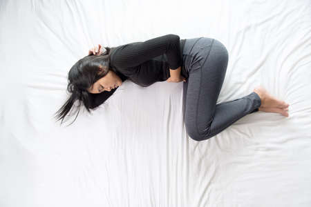 Pregnant female nausea in bedroom,Asian woman with morning sickness,Indigestibleの写真素材