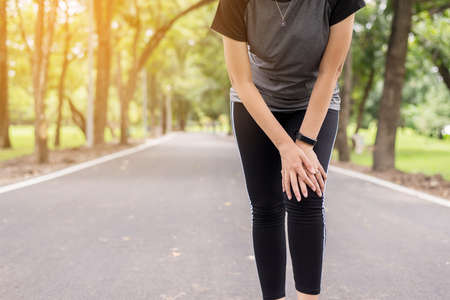 Woman suffering from pain in leg injury after sport exercise running jogging and workout outdoor