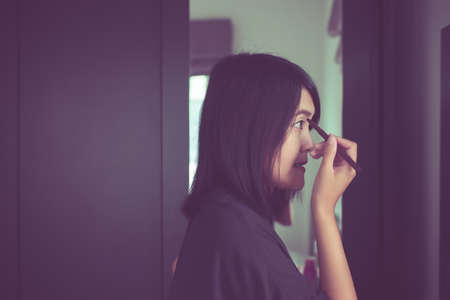 Makeup and beautiful woman face,Beautiful young female correcting eyebrow shape with brush