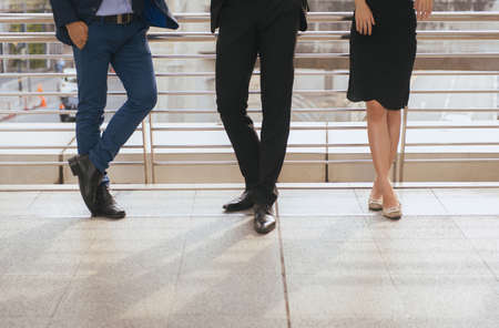 Cropped image of business team working and meeting while standing together outdoorの写真素材