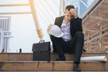 Businessman feeling stressed and tired frustrated failure exhausted covering face,head with hand