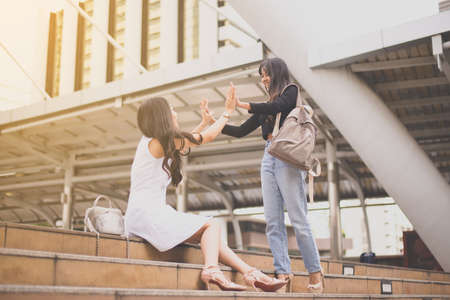 Woman hands meeting,Happy greeting of two friends in the city