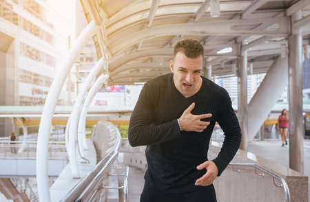 Man with strong chest pain and hands touching his chest,Heart attack symptomの写真素材