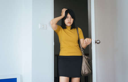 Asian female have a headache before going to work in the morning at homeの写真素材