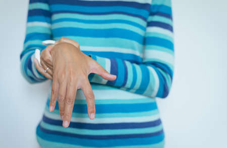 Close up of hand woman suffering with Parkinson disease symptoms,Women patient with shaking hands